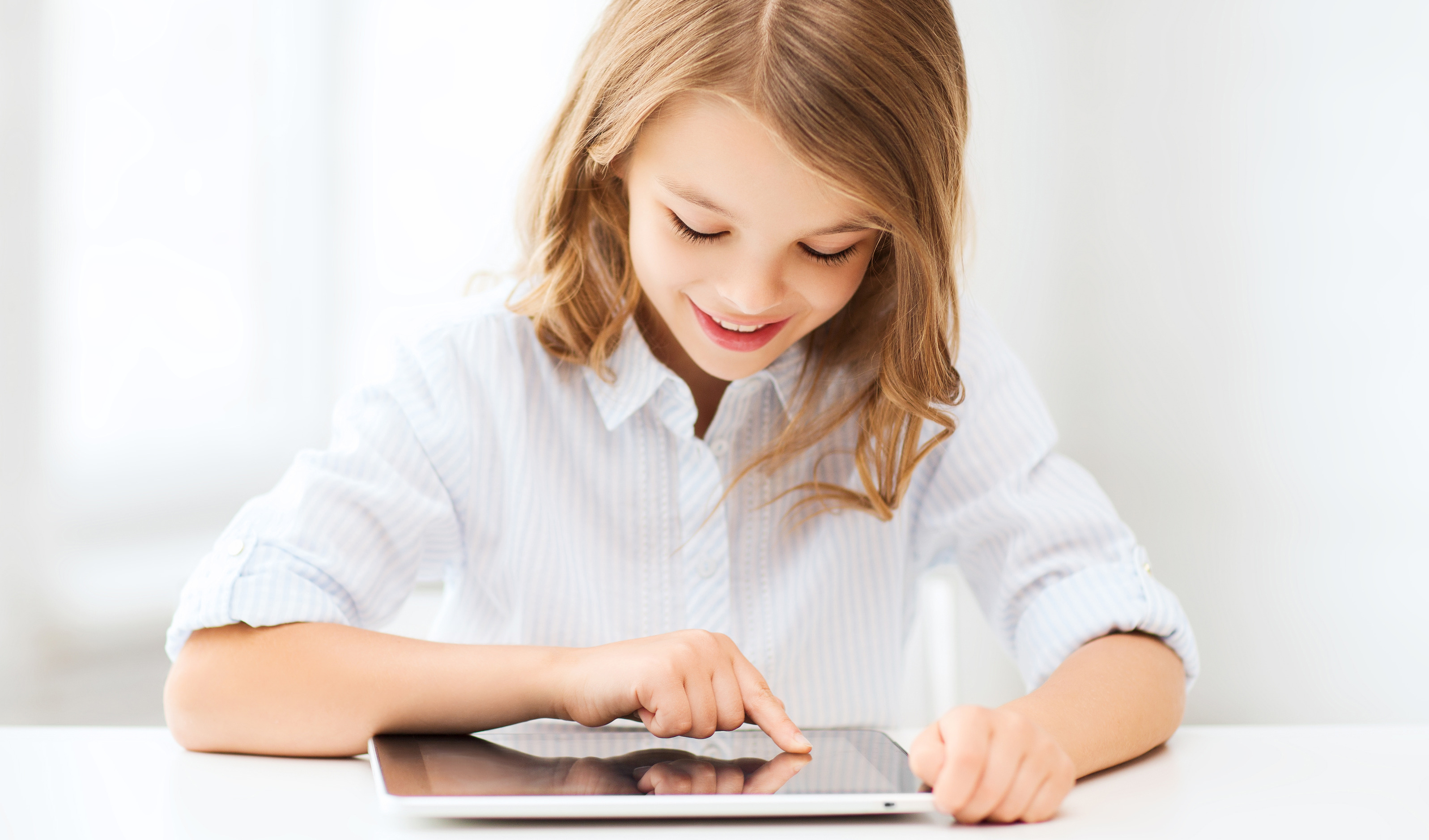 girl in school uniform on tablet